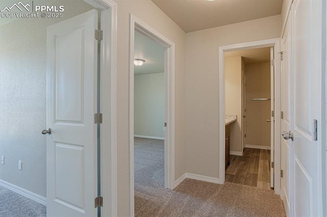 hallway with light colored carpet