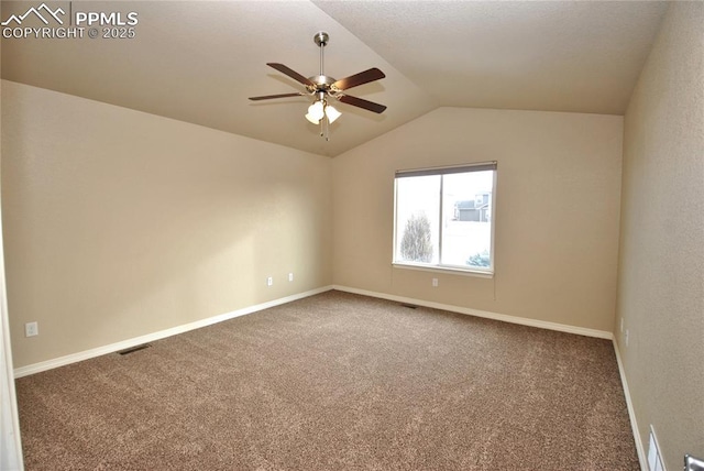 spare room featuring ceiling fan, carpet flooring, and vaulted ceiling