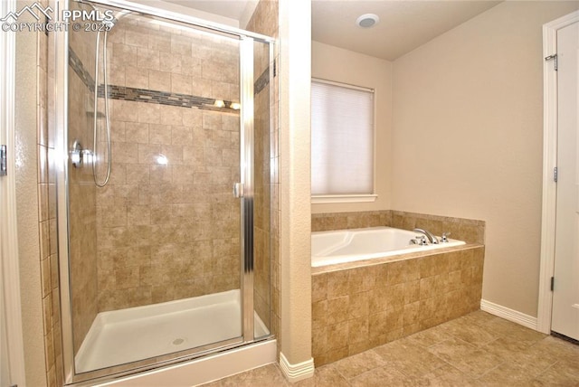 bathroom featuring tile patterned floors and separate shower and tub