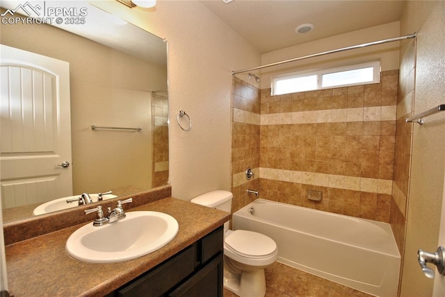 full bathroom with tiled shower / bath combo, vanity, tile patterned floors, and toilet