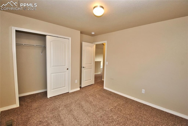 unfurnished bedroom with carpet floors and a closet