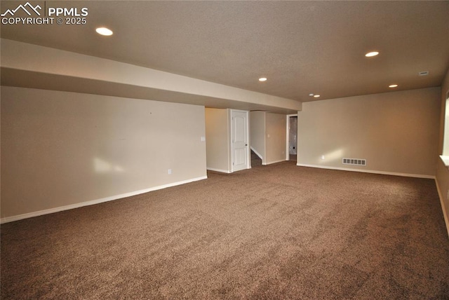 basement featuring dark colored carpet