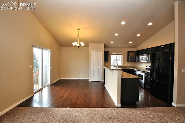 kitchen featuring appliances with stainless steel finishes, pendant lighting, a chandelier, light stone countertops, and dark wood-type flooring