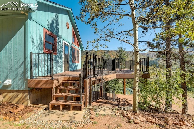 view of home's exterior featuring a deck with mountain view