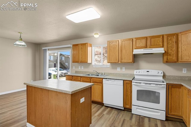 332 Ellers Grv, Colorado Springs, CO 80916 - kitchen with sink, decorative light fixtures, a center island, white appliances, and light hardwood / wood-style floors