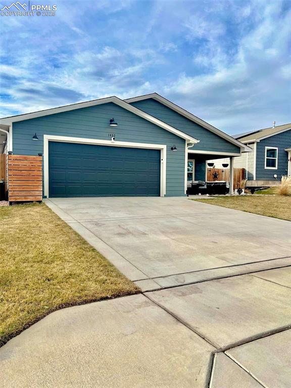 ranch-style home with a front yard and a garage