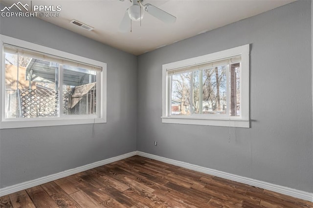 unfurnished room with ceiling fan and dark hardwood / wood-style flooring