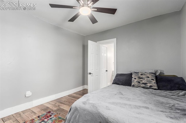 bedroom with ceiling fan and hardwood / wood-style floors