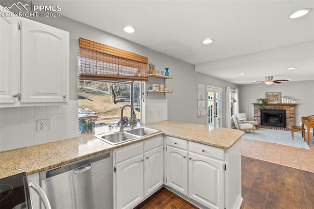 kitchen with white cabinetry, dishwasher, and sink