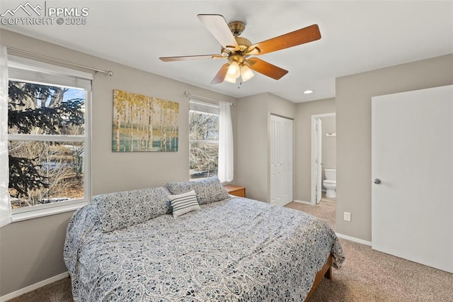 bedroom with ceiling fan, carpet, a closet, and ensuite bath