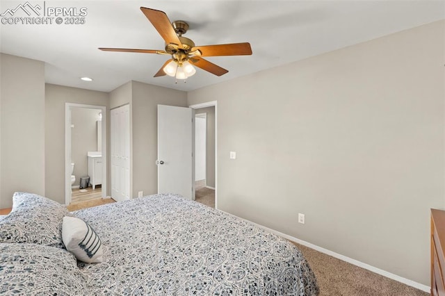 bedroom with ceiling fan, carpet, and ensuite bathroom