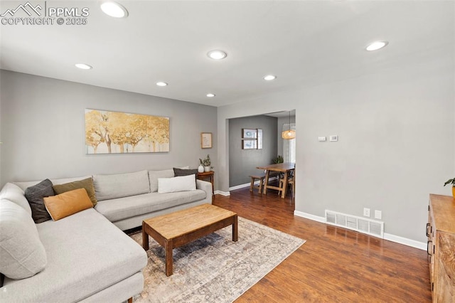 living room featuring dark wood-type flooring