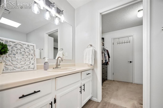 bathroom featuring vanity and a textured ceiling