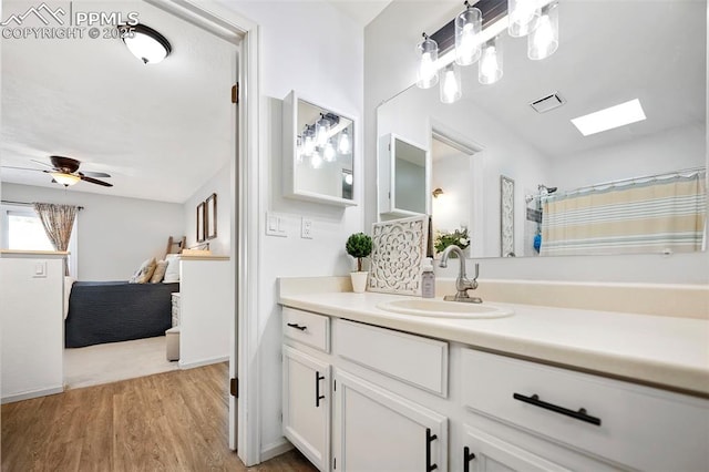 bathroom with ceiling fan, wood-type flooring, and vanity