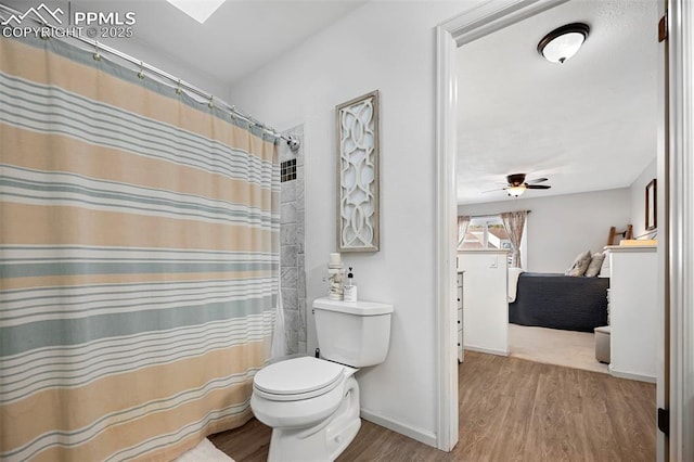 bathroom featuring ceiling fan, a shower with curtain, wood-type flooring, and toilet