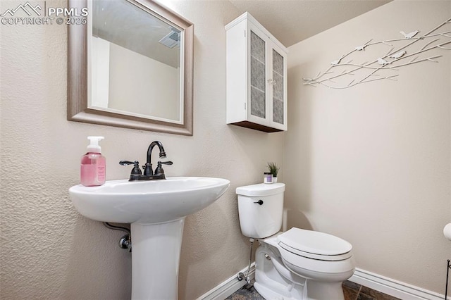 bathroom featuring sink and toilet