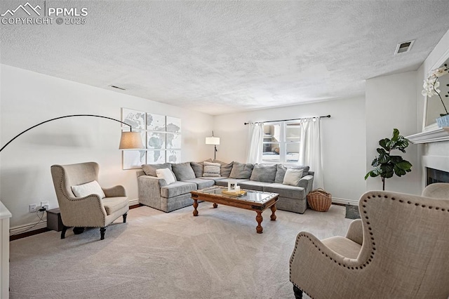 living room featuring light colored carpet and a textured ceiling