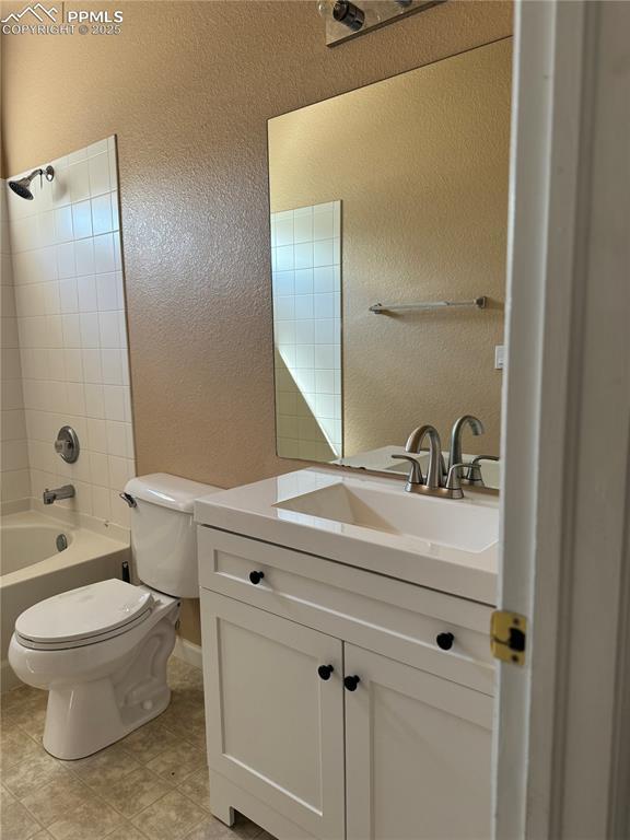 full bathroom featuring vanity, toilet, and bathtub / shower combination