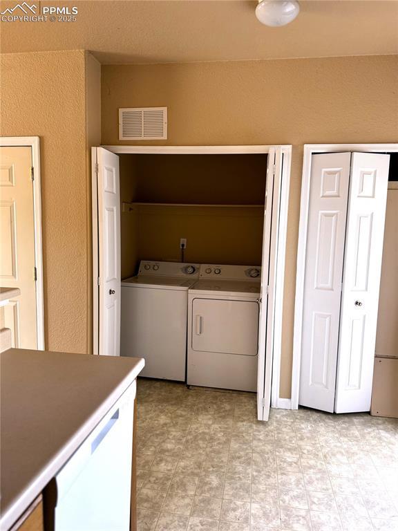 laundry area featuring washing machine and clothes dryer