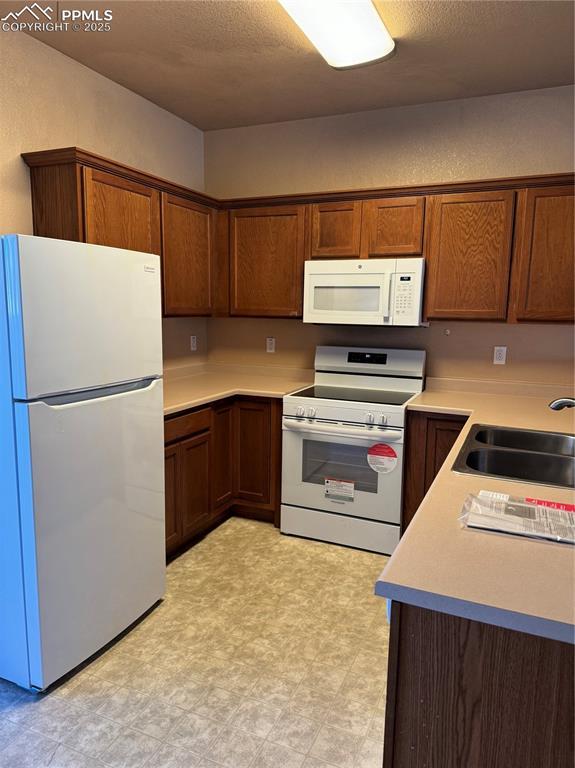 kitchen with sink and white appliances