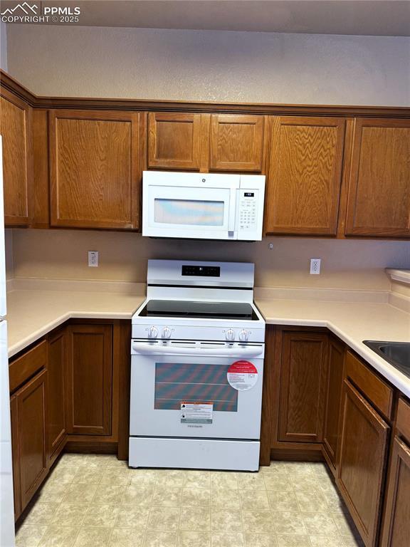 kitchen with sink and white appliances