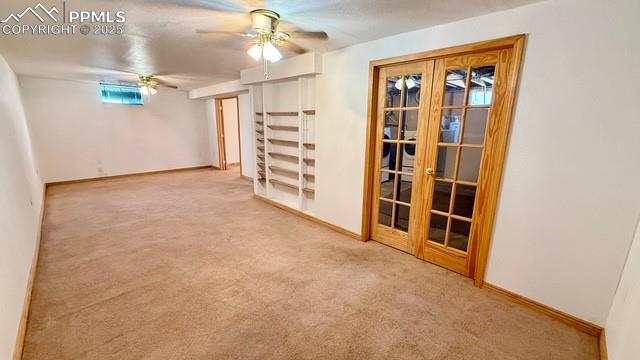 basement with ceiling fan and carpet flooring