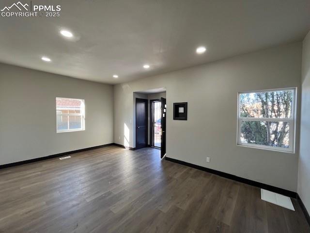 spare room with dark hardwood / wood-style flooring