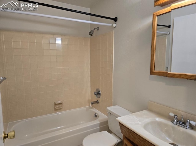 full bathroom featuring vanity, toilet, and tiled shower / bath