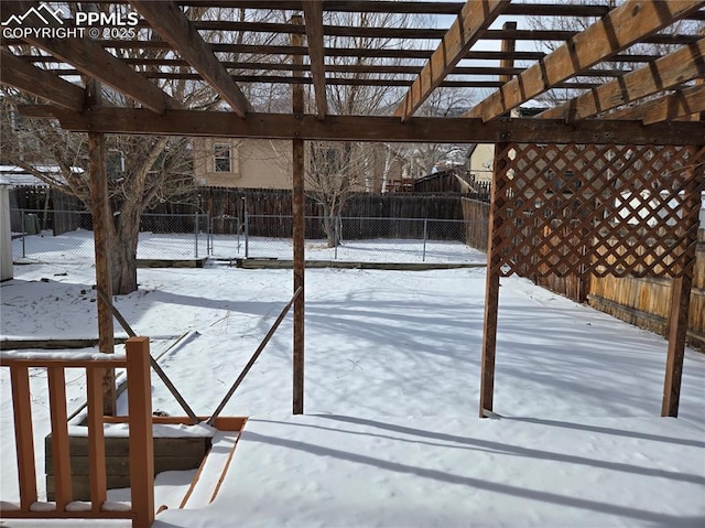 yard layered in snow featuring a pergola