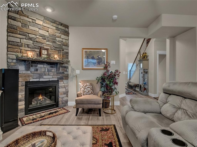 living room featuring hardwood / wood-style flooring and a fireplace