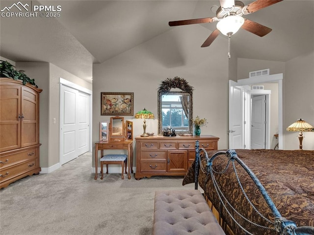 bedroom featuring ceiling fan, light carpet, a closet, and lofted ceiling