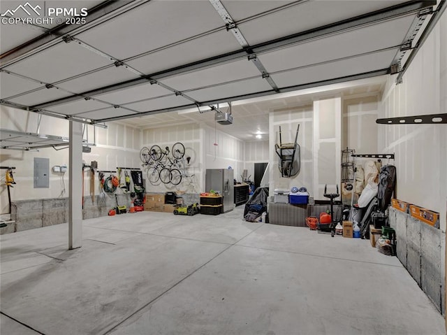 garage with electric panel and a garage door opener