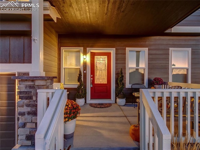 doorway to property featuring covered porch