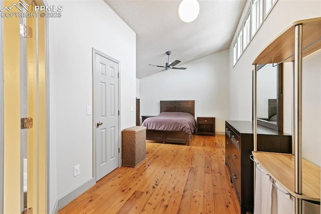 bedroom featuring ceiling fan, vaulted ceiling, and light hardwood / wood-style flooring