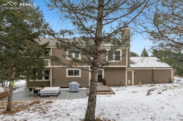 snow covered property with a wooden deck