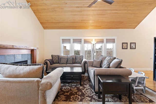 living room featuring a tile fireplace, lofted ceiling, hardwood / wood-style flooring, ceiling fan, and wooden ceiling