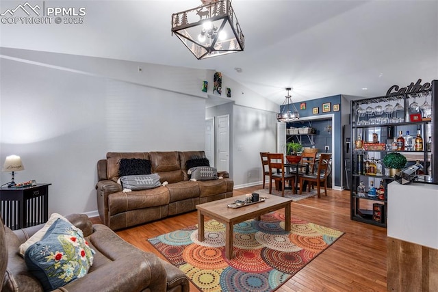 living room with hardwood / wood-style flooring and vaulted ceiling