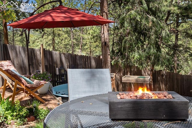 view of patio / terrace with a fire pit