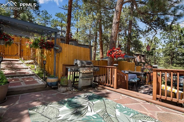 wooden deck featuring area for grilling