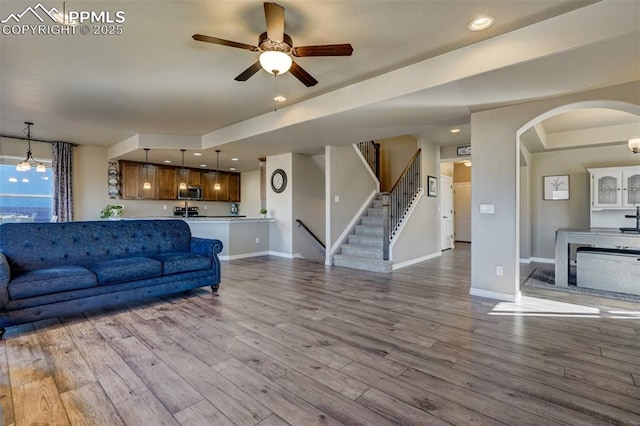 living room featuring ceiling fan and light hardwood / wood-style flooring