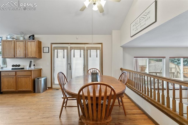 dining room with light wood-type flooring, ceiling fan, and lofted ceiling