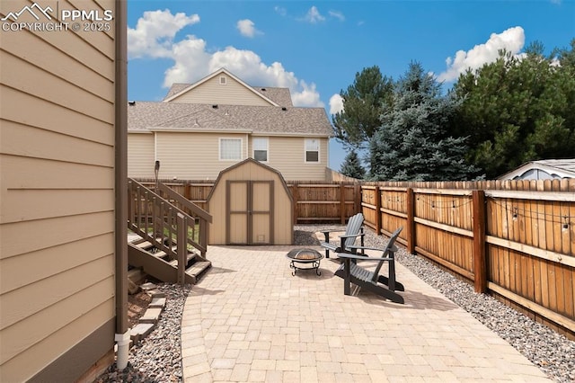 view of patio / terrace with a fire pit and a storage unit