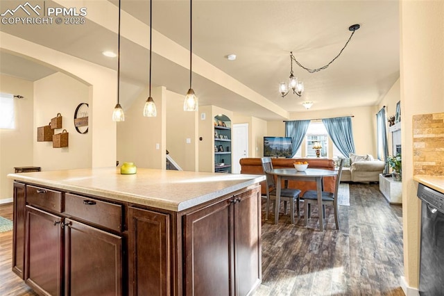 kitchen with dark hardwood / wood-style flooring, hanging light fixtures, black dishwasher, and an inviting chandelier