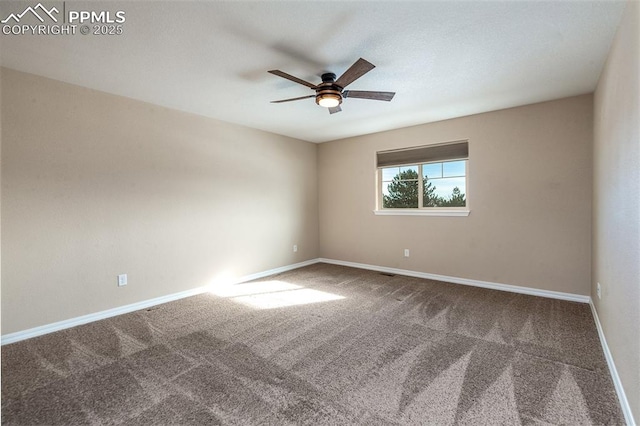 spare room featuring ceiling fan and carpet floors