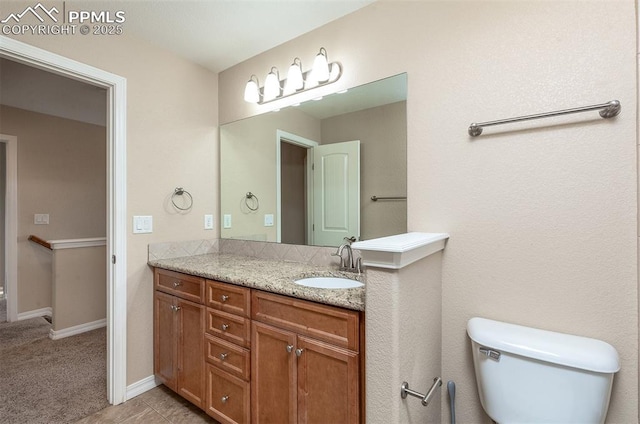 bathroom with vanity, toilet, and tile patterned floors