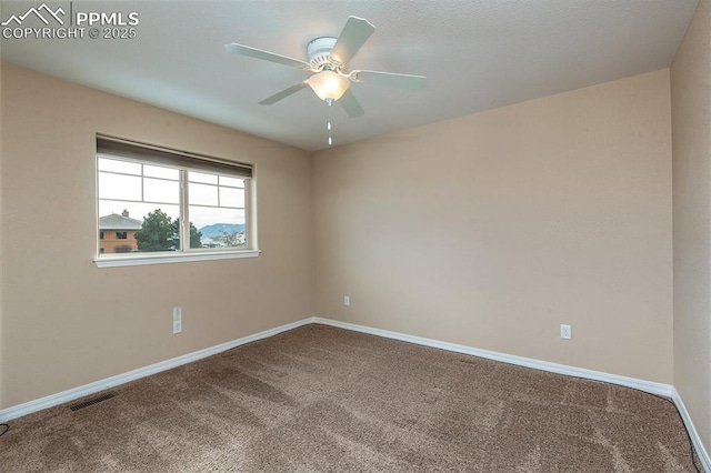 empty room with ceiling fan and carpet flooring