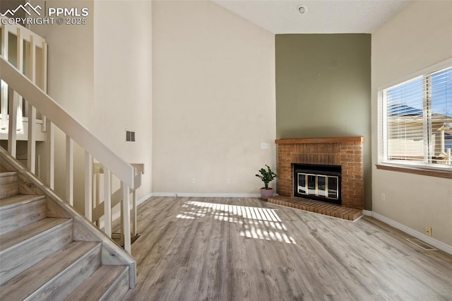 unfurnished living room featuring wood-type flooring and a fireplace