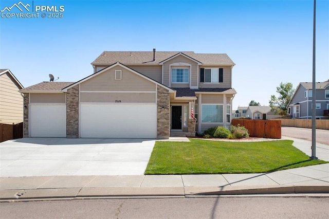 view of front of house featuring a garage and a front lawn