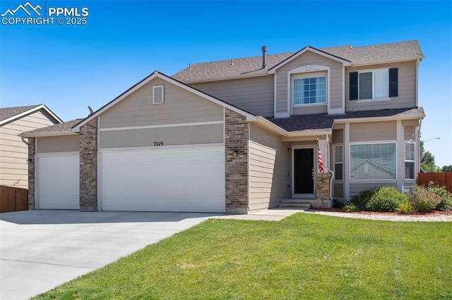 view of front of property featuring a garage and a front yard