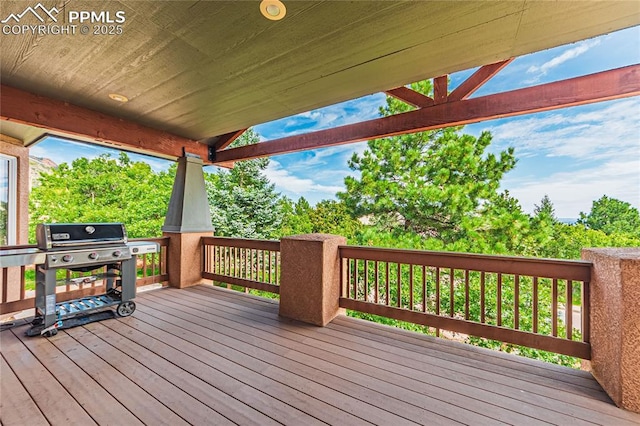 wooden deck with a grill